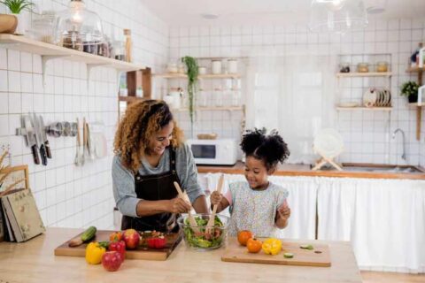 Women cooking food with daughter