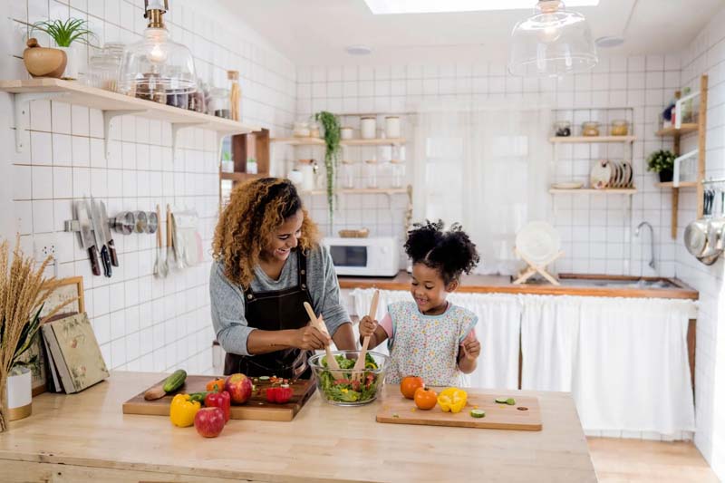Women cooking food with daughter